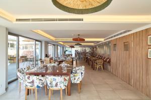 a dining room with tables and chairs in a restaurant at Can Salia in San Antonio Bay