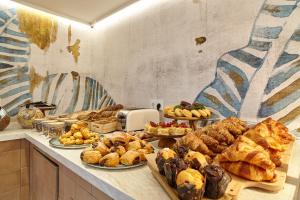 a buffet with many different types of bread and pastries at Can Salia in San Antonio Bay