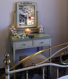 a dressing table with a candle and a candle at Palaeopoli Villas in Avlemonas