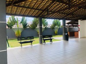 a group of benches in a building with plants at APêAju - Apartamento com tudo novinho só para você in Aracaju