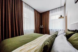 a bedroom with a bed and a large window at Old Town apartment l Self check in in Vilnius