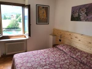 Katil atau katil-katil dalam bilik di Appartamento sul Lago di Molveno