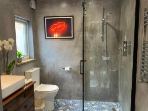 a bathroom with a shower with a toilet and a sink at Selsey 5 mins walk to the beach in Selsey
