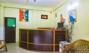 a wooden reception desk in a room at Treebo Trend JKR Residency in Shillong