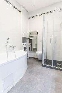 a white bathroom with a tub and a shower at CLOSE CROISETTE-MODERN-A/C-CONGRESS-BEACHES in Cannes