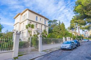 a house with a car parked in front of a fence at CLOSE CROISETTE-MODERN-A/C-CONGRESS-BEACHES in Cannes