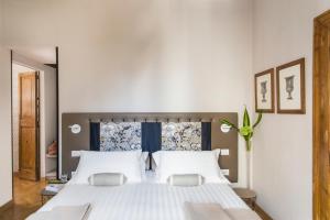 a bedroom with a large white bed with two pillows at NavonaMyHome in Rome