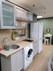 a kitchen with a sink and a washing machine at Ilyinskiy Hostel in Nizhny Novgorod