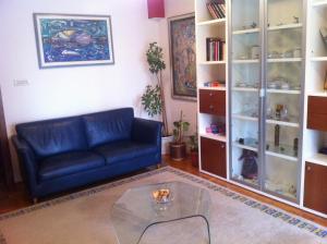 a living room with a blue couch and a glass table at Apartment 4 you in Split