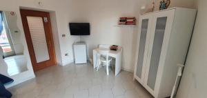 a room with a small table and a tv on the wall at Il Balconcino in Naples