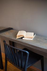 a wooden table with a book on it at Emporikon Athens Hotel in Athens