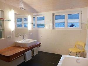 a white bathroom with a sink and a tub at Ferienwohnung Imberger Horn - Sonthofen in Sonthofen +13 photos