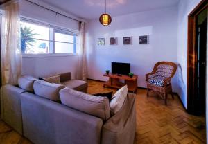 a living room with a couch and a tv at FLH Loulé Balcony Spacey Apartment in Loulé