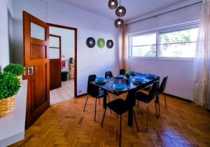 a dining room with a black table and chairs at FLH Loulé Balcony Spacey Apartment in Loulé