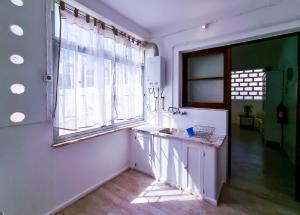 a bathroom with a sink and a large window at FLH Loulé Balcony Spacey Apartment in Loulé