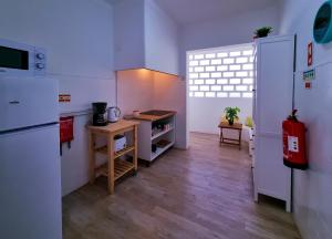 a kitchen with a refrigerator and a table in it at FLH Loulé Balcony Spacey Apartment in Loulé