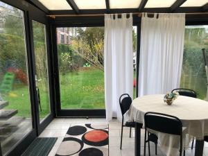 a dining room with a table and a large window at Residence Lilac in Brussels