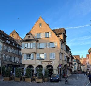 a large building on a street in a city at Le Balcon de Colmar in Colmar