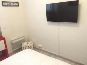 a room with a flat screen tv on a wall at MAGNIFIQUE T3 85m2 VIEUX PORT/CORNICHE in Marseille