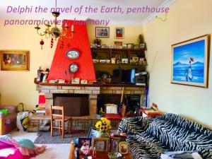 ein Wohnzimmer mit einem Kamin und einer roten Struktur in der Unterkunft Delphi celebrity v i p the navel of the Earth, CENTER-DELPHI-penthouse galaxy&sky panoramic view, harmony&YOGA in Delphi