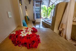 a room with a red carpet and white walls at Sunshine Hotel Zanzibar in Matemwe
