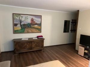 uma sala de estar com um sofá e uma pintura na parede em Riia 10, 2-bedroom apartment - 2 big beds 1 extra bed-parking free em Tartu