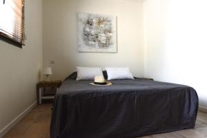 a bedroom with a bed with a hat on it at LE GALLI en plein cœur de Sanary in Sanary-sur-Mer
