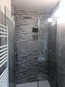 a shower with a glass door in a bathroom at La Casa di Zoe al borgo in Perugia