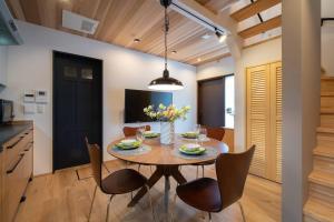 a kitchen and dining room with a table and chairs at OCHANOMA in Ebisuchō