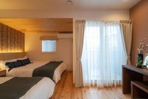 Кровать или кровати в номере OCHANOMA