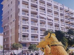 a giant pineapple statue in front of a building at Hotel Chambord in Menton