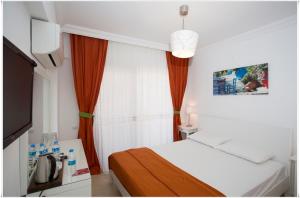 Postel nebo postele na pokoji v ubytování Ayka Hotel