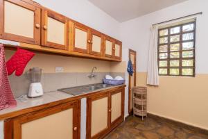 a kitchen with a sink and a counter top at Eden House Cottages in Malindi