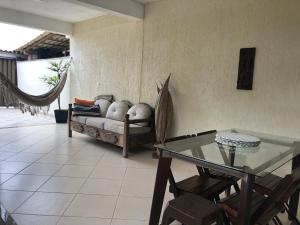 a living room with a couch and a glass table at Flats Ponta do Sapê in Angra dos Reis