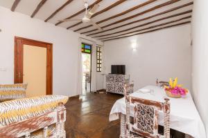 a living room with a table and chairs at Eden House Cottages in Malindi