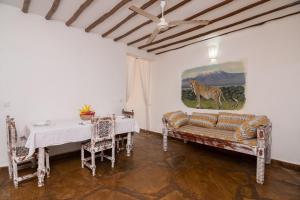 a living room with a couch and a table at Eden House Cottages in Malindi