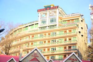 a building with a hotel sign on top of it at Move-N-Pick Murree in Murree