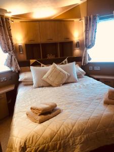 1 dormitorio con 1 cama grande y toallas. en Rymmon Retreat en Orkney