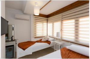 Postel nebo postele na pokoji v ubytování Ayka Hotel