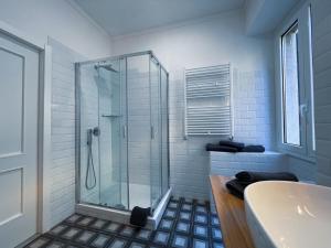 a bathroom with a glass shower and a tub at Guest House S.Caterina in Viterbo