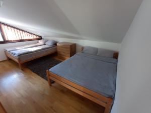 a bedroom with a bed and a couch in it at Jahorina apartman 54m2 (za 6 osoba) in Jahorina