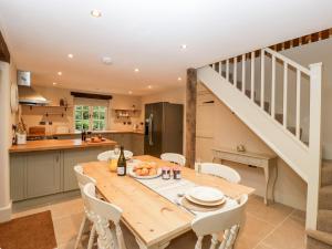 a kitchen and dining room with a wooden table and chairs at The Coach House15 in Warminster