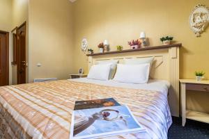 a hotel room with a bed with a book on it at Blues na Nevskom in Saint Petersburg