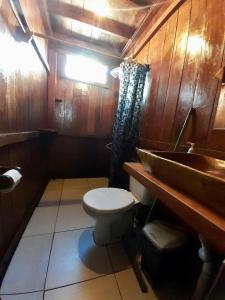 a bathroom with a toilet and a sink at Kite Point Atins in Atins