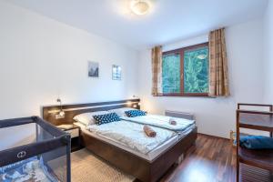 A bed or beds in a room at Apartment Amelia Tale, View of Chopok from large terrace, In the nature