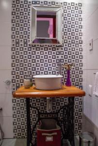 a bathroom with a sink and a mirror on a table at Cane B&B in Montevideo +41 photos