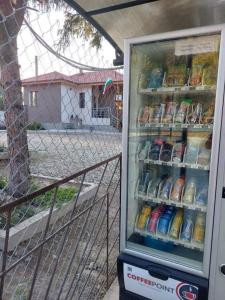 a refrigerator full of food and drinks next to a fence at Квартири ЦЕНТРАЛ in Dolna Mitropoliya
