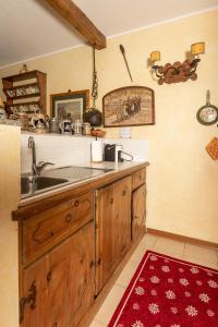 a kitchen with a sink and a counter at Chalet Casericc in Bormio