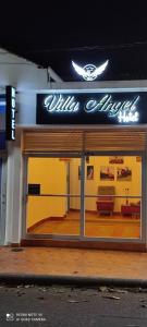 a window of a building with a sign on it at Hotel Villa Ángel in Neiva