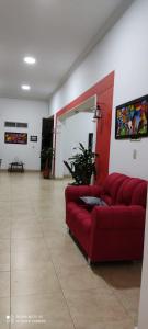 a living room with a red couch in a room at Hotel Villa Ángel in Neiva